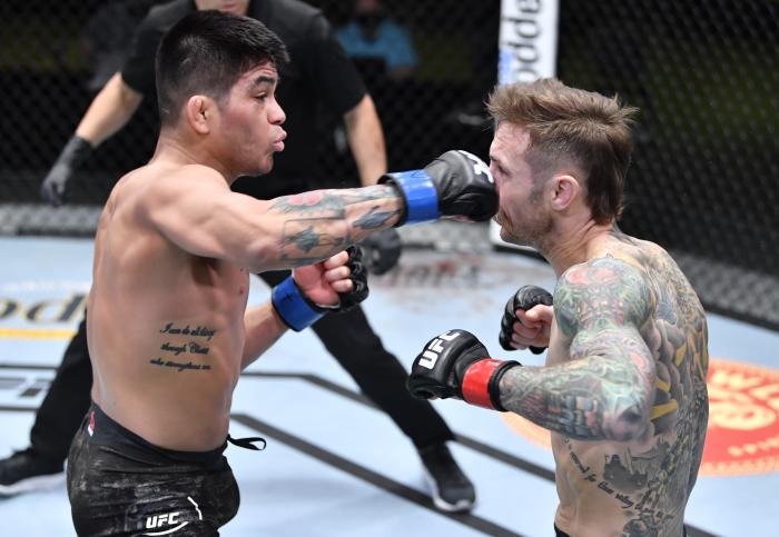 John Castaneda punches Eddie Wineland in a bantamweight bout during the UFC Fight Night event at UFC APEX on February 20, 2021 in Las Vegas, Nevada. (Photo by Chris Unger/Zuffa LLC)