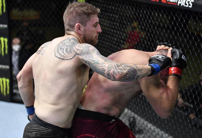 Chris Daukaus punches Aleksei Oleinik of Russia in a heavyweight bout during the UFC Fight Night event at UFC APEX on February 20, 2021 in Las Vegas, Nevada. (Photo by Chris Unger/Zuffa LLC)