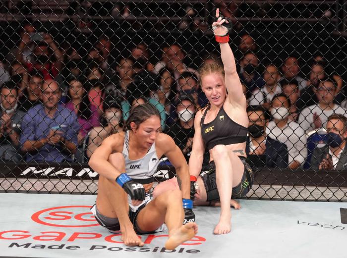 Valentina Shevchenko and Taila Santos react after their UFC flyweight championship fight at UFC 275