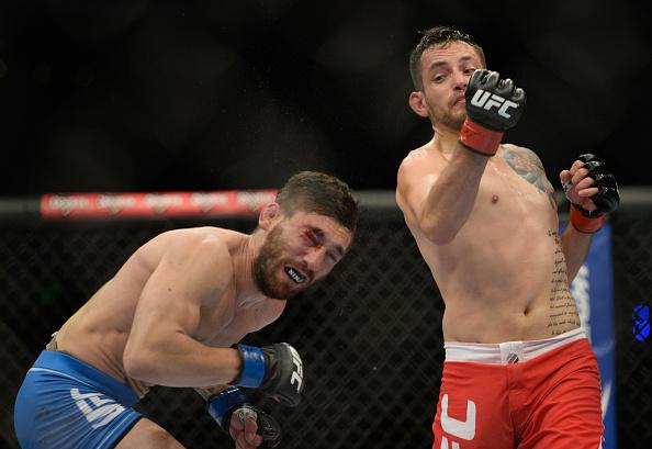 MEXICO CITY, MEXICO - NOVEMBER 15: (R-L) Henry Briones punches Guido Cannetti in their bantamweight bout during the UFC 180 event at Arena Ciudad de Mexico on November 15, 2014 in Mexico City, Mexico. (Photo by Jeff Bottari/Zuffa LLC/Zuffa LLC via Getty