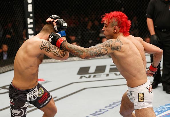 MEXICO CITY, MEXICO - NOVEMBER 15: (R-L) Augusto Montano punches Chris Heatherly in their welterweight bout during the UFC 180 event at Arena Ciudad de Mexico on November 15, 2014 in Mexico City, Mexico. (Photo by Josh Hedges/Zuffa LLC/Zuffa LLC via Get