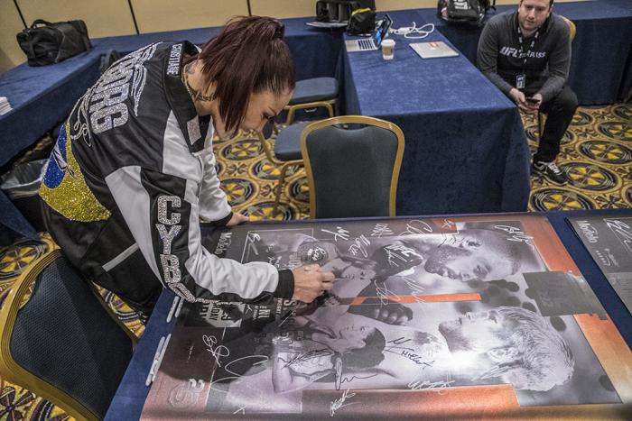 Cris Cyborg signs UFC 232 posters