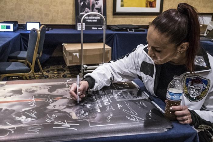 Cris Cyborg signs UFC 232 posters