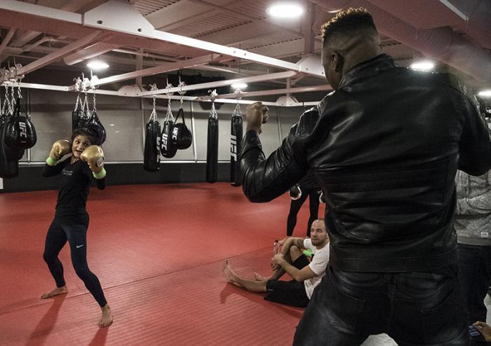 Las Vegas 12/27/17 - Cynthia Calvillo with Francis Ngannou practicing the KO upper during UFC 219 fight week. (Photo credit Juan Cardenas)