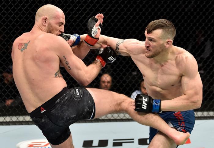 LAS VEGAS, NV - MARCH 03:   (R-L) Adam Milstead punches Jordan Johnson in their light heavyweight bout during the UFC 222 event inside T-Mobile Arena on March 3, 2018 in Las Vegas, Nevada. (Photo by Jeff Bottari/Zuffa LLC/Zuffa LLC via Getty Images)