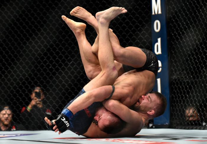 LAS VEGAS, NV - MARCH 03:   (R-L) Bryan Caraway attempts to secure a guillotine choke submission against Cody Stamann in their bantamweight bout during the UFC 222 event inside T-Mobile Arena on March 3, 2018 in Las Vegas, Nevada. (Photo by Brandon Magnus