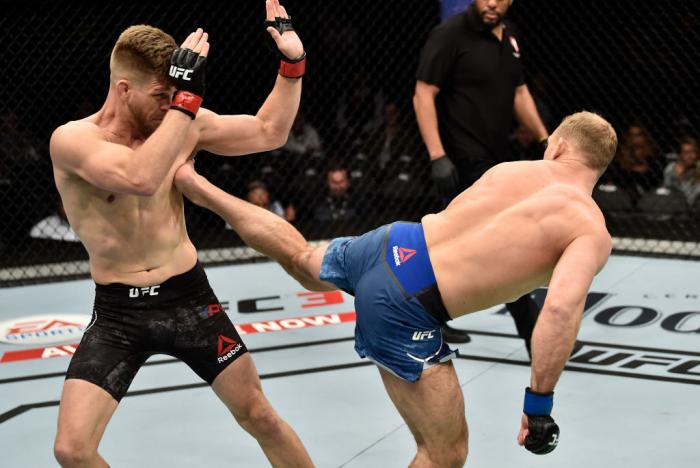 LAS VEGAS, NV - MARCH 03:   (R-L) Zak Ottow kicks Mike Pyle in their welterweight bout during the UFC 222 event inside T-Mobile Arena on March 3, 2018 in Las Vegas, Nevada. (Photo by Jeff Bottari/Zuffa LLC)