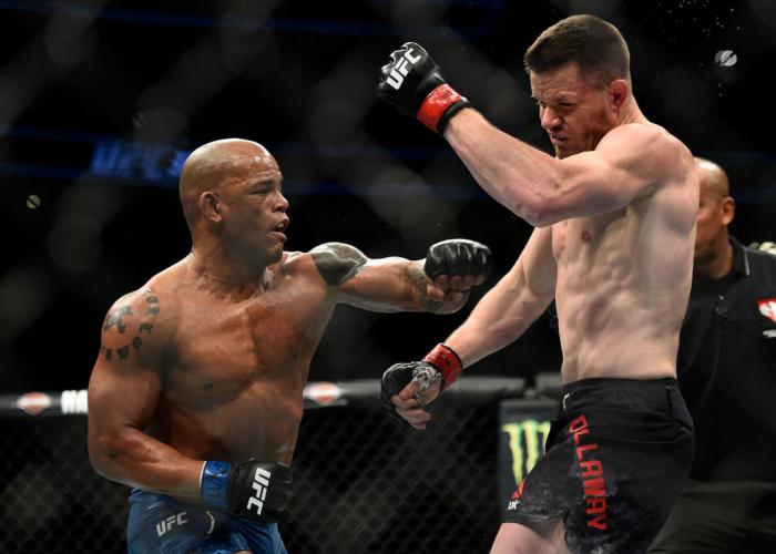 LAS VEGAS, NV - MARCH 03:   (L-R) Hector Lombard of Cuba lands an illegal punch after the end of round one against CB Dollaway in their middleweight bout during the UFC 222 event inside T-Mobile Arena on March 3, 2018 in Las Vegas, Nevada. (Photo by Brand