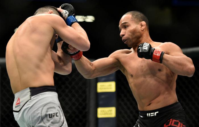 LAS VEGAS, NV - MARCH 03:   (R-L) John Dodson punches Pedro Munhoz of Brazil in their bantamweight bout during the UFC 222 event inside T-Mobile Arena on March 3, 2018 in Las Vegas, Nevada. (Photo by Brandon Magnus/Zuffa LLC)