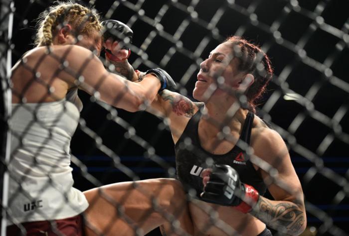 LAS VEGAS, NV - MARCH 03:   (R-L) Cris Cyborg of Brazil punches Yana Kunitskaya of Russia in their women's featherweight bout during the UFC 222 event inside T-Mobile Arena on March 3, 2018 in Las Vegas, Nevada. (Photo by Brandon Magnus/Zuffa LLC)