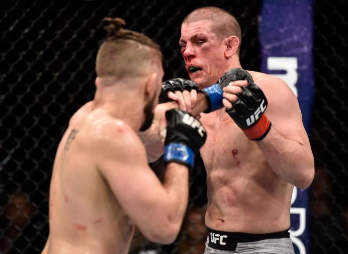 BROOKLYN, NEW YORK - APRIL 07:  (L-R) Chris Gruetzemacher punches Joe Lauzon in their lightweight bout during the UFC 223 event inside Barclays Center on April 7, 2018 in Brooklyn, New York. (Photo by Jeff Bottari/Zuffa LLC)