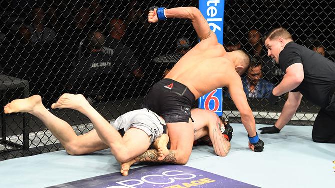 CHICAGO, ILLINOIS - JUNE 09:  (R-L) Dan Ige punches Mike Santiago in their featherweight fight during the UFC 225 event at the United Center on June 9, 2018 in Chicago, Illinois. (Photo by Josh Hedges/Zuffa LLC/Zuffa LLC via Getty Images)