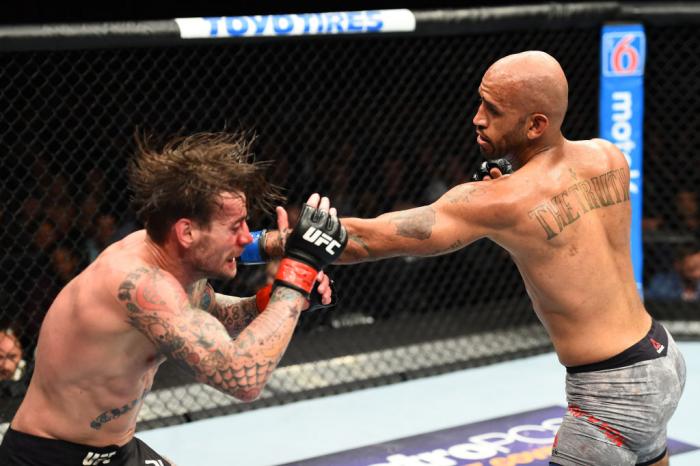 CHICAGO, ILLINOIS - JUNE 09: (R-L) Mike Jackson punches CM Punk in their welterweight fight during the UFC 225 event at the United Center on June 9, 2018 in Chicago, Illinois. (Photo by Josh Hedges/Zuffa LLC/Zuffa LLC via Getty Images)