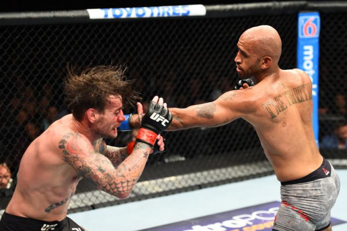 CHICAGO, ILLINOIS - JUNE 09:  (R-L) Mike Jackson punches CM Punk in their welterweight fight during the UFC 225 event at the United Center on June 9, 2018 in Chicago, Illinois. (Photo by Josh Hedges/Zuffa LLC/Zuffa LLC via Getty Images)