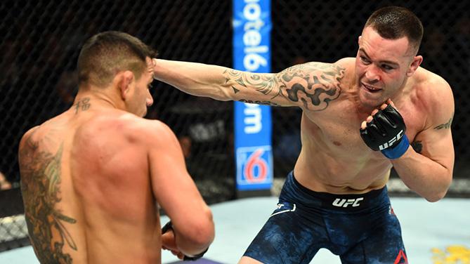 CHICAGO, ILLINOIS - JUNE 09:  (R-L) Colby Covington punches Rafael Dos Anjos of Brazil in their interim welterweight title fight during the UFC 225 event at the United Center on June 9, 2018 in Chicago, Illinois. (Photo by Josh Hedges/Zuffa LLC/Zuffa LLC 