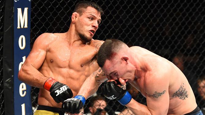 CHICAGO, ILLINOIS - JUNE 09: (L-R) Rafael Dos Anjos of Brazil punches Colby Covington in their interim welterweight title fight during the UFC 225 event at the United Center on June 9, 2018 in Chicago, Illinois. (Photo by Josh Hedges/Zuffa LLC/Zuffa LLC