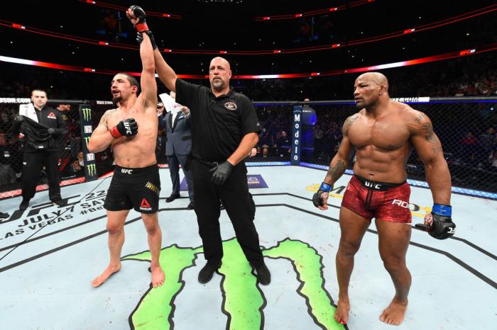 CHICAGO, ILLINOIS - JUNE 09:  (L-R) Robert Whittaker of New Zealand reacts after defeating Yoel Romero of Cuba in their middleweight fight during the UFC 225 event at the United Center on June 9, 2018 in Chicago, Illinois. Whittaker won by split decision.