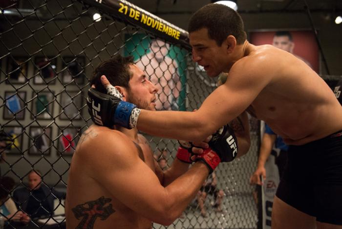 LAS VEGAS, NV - MARCH 24: (R-L) Cesar Arzamendia checks that Oliver Meza is not hurt after their fight during the filming of The Ultimate Fighter Latin America: Team Gastelum vs Team Escudero on March 24, 2015 in Las Vegas, Nevada. (Photo by Brandon Mag