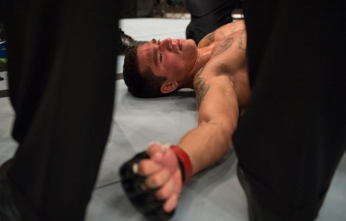 LAS VEGAS, NV - MARCH 27: Marco Olano lays on the canvas as his arm gets wrapped up after getting a compound fracture during the filming of The Ultimate Fighter Latin America: Team Gastelum vs Team Escudero on March 27, 2015 in Las Vegas, Nevada. (Photo