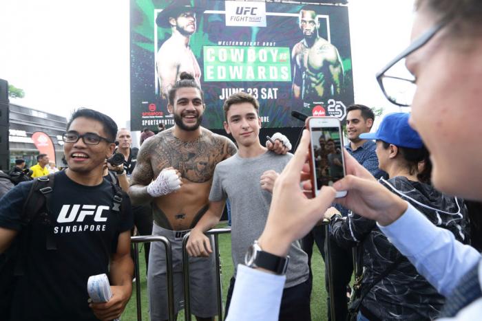 SINGAPORE - JUNE 20: Tyson Pedro (C) of Australia poses for a photo with fans during the UFC Fight Night Open Workout at OCBC Square on June 20, 2018 in Singapore. (Photo by Suhaimi Abdullah - Zuffa LLC/Zuffa LLC)