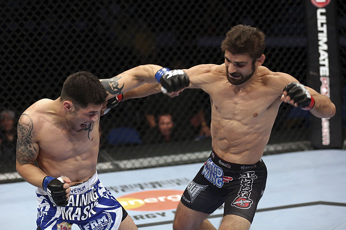 CALGARY, CANADA - JULY 21: (R-L) Antonio Carvalho lands a punch on Daniel Pineda during their featherweight bout at UFC 149 inside the Scotiabank Saddledome on July 21, 2012 in Calgary, Alberta, Canada. (Photo by Nick Laham/Zuffa LLC/Zuffa LLC via Getty