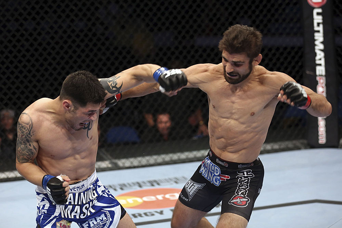 CALGARY, CANADA - JULY 21: (R-L) Antonio Carvalho lands a punch on Daniel Pineda during their featherweight bout at UFC 149 inside the Scotiabank Saddledome on July 21, 2012 in Calgary, Alberta, Canada.  (Photo by Nick Laham/Zuffa LLC/Zuffa LLC via Getty 