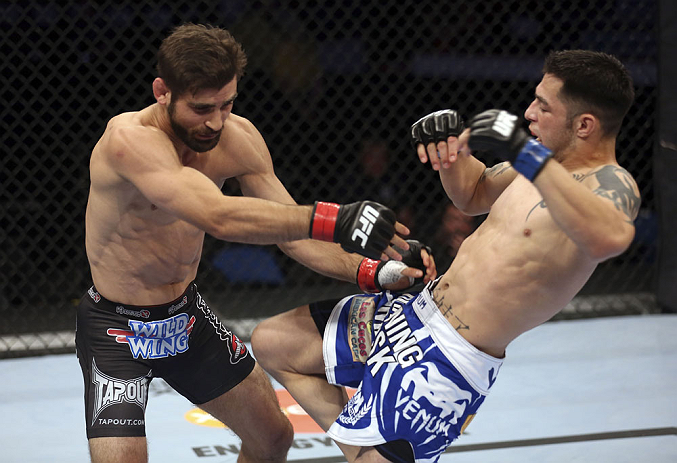 CALGARY, CANADA - JULY 21: (L-R) Antonio Carvalho exchanges punches with Daniel Pineda during their featherweight bout at UFC 149 inside the Scotiabank Saddledome on July 21, 2012 in Calgary, Alberta, Canada.  (Photo by Nick Laham/Zuffa LLC/Zuffa LLC via 