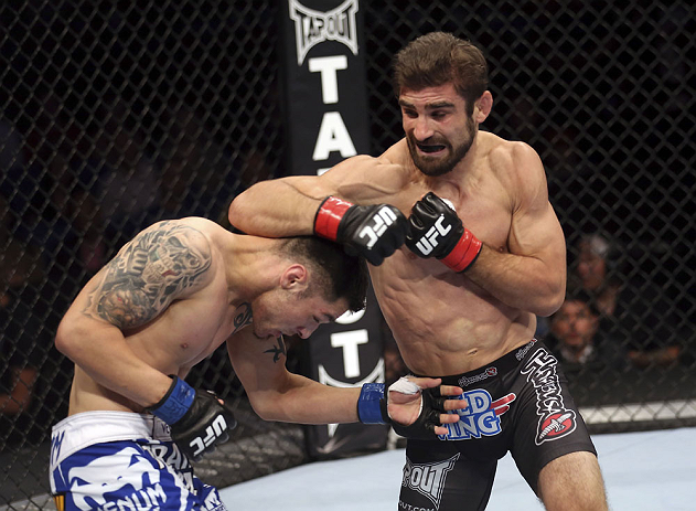 CALGARY, CANADA - JULY 21:  (R-L) Antonio Carvalho exchanges punches with Daniel Pineda during their featherweight bout at UFC 149 inside the Scotiabank Saddledome on July 21, 2012 in Calgary, Alberta, Canada.  (Photo by Nick Laham/Zuffa LLC/Zuffa LLC via