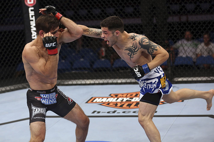 CALGARY, CANADA - JULY 21: (R-L) Daniel Pineda throws a punch at Antonio Carvalho during their featherweight bout at UFC 149 inside the Scotiabank Saddledome on July 21, 2012 in Calgary, Alberta, Canada. (Photo by Nick Laham/Zuffa LLC/Zuffa LLC via Getty