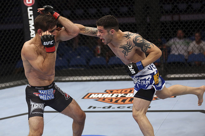 CALGARY, CANADA - JULY 21: (R-L) Daniel Pineda throws a punch at Antonio Carvalho during their featherweight bout at UFC 149 inside the Scotiabank Saddledome on July 21, 2012 in Calgary, Alberta, Canada.  (Photo by Nick Laham/Zuffa LLC/Zuffa LLC via Getty