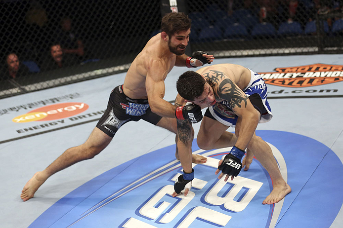 CALGARY, CANADA - JULY 21: (L-R) Antonio Carvalho lands a knockout punch on Daniel Pineda during their featherweight bout at UFC 149 inside the Scotiabank Saddledome on July 21, 2012 in Calgary, Alberta, Canada. (Photo by Nick Laham/Zuffa LLC/Zuffa LLC v