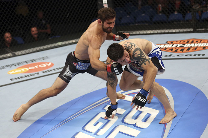 CALGARY, CANADA - JULY 21: (L-R) Antonio Carvalho lands a knockout punch on Daniel Pineda during their featherweight bout at UFC 149 inside the Scotiabank Saddledome on July 21, 2012 in Calgary, Alberta, Canada.  (Photo by Nick Laham/Zuffa LLC/Zuffa LLC v