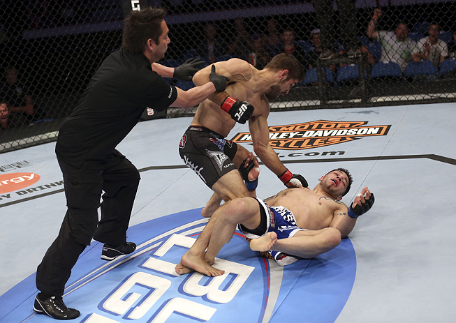 CALGARY, CANADA - JULY 21: (L-R) Referee Mario Yamasaki pulls Antonio Carvalho off Daniel Pineda after a knockout punch during their featherweight bout at UFC 149 inside the Scotiabank Saddledome on July 21, 2012 in Calgary, Alberta, Canada. (Photo by N