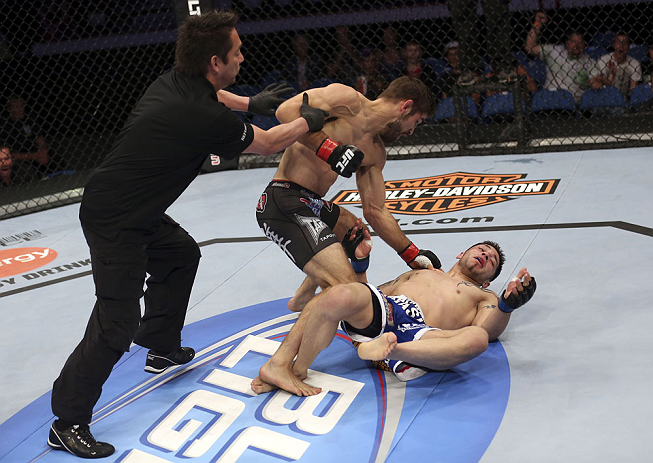 CALGARY, CANADA - JULY 21:  (L-R) Referee Mario Yamasaki pulls Antonio Carvalho off Daniel Pineda after a knockout punch during their featherweight bout at UFC 149 inside the Scotiabank Saddledome on July 21, 2012 in Calgary, Alberta, Canada.  (Photo by N