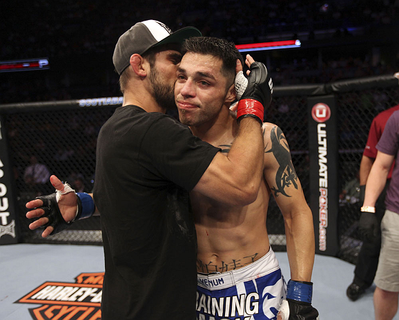 CALGARY, CANADA - JULY 21: (L-R) Antonio Carvalho hugs Daniel Pineda after Pineda was defeated by knockout in the first round during their featherweight bout at UFC 149 inside the Scotiabank Saddledome on July 21, 2012 in Calgary, Alberta, Canada.  (Photo