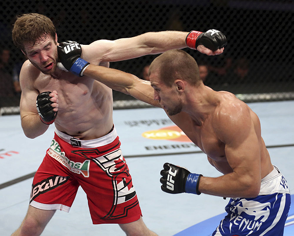 CALGARY, CANADA - JULY 21: (R-L) Anton Kuivanen lands a punch on Mitch Clarke during their lightweight bout at UFC 149 inside the Scotiabank Saddledome on July 21, 2012 in Calgary, Alberta, Canada. (Photo by Nick Laham/Zuffa LLC/Zuffa LLC via Getty Image