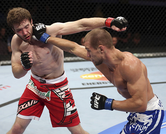 CALGARY, CANADA - JULY 21: (R-L) Anton Kuivanen lands a punch on Mitch Clarke during their lightweight bout at UFC 149 inside the Scotiabank Saddledome on July 21, 2012 in Calgary, Alberta, Canada.  (Photo by Nick Laham/Zuffa LLC/Zuffa LLC via Getty Image