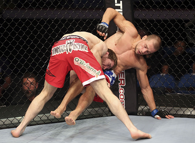 CALGARY, CANADA - JULY 21: Mitch Clarke takes down Anton Kuivanen during their lightweight bout at UFC 149 inside the Scotiabank Saddledome on July 21, 2012 in Calgary, Alberta, Canada. (Photo by Nick Laham/Zuffa LLC/Zuffa LLC via Getty Images)