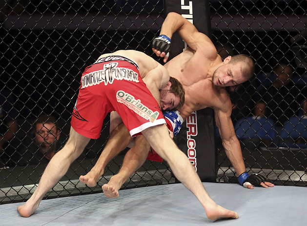 CALGARY, CANADA - JULY 21:  Mitch Clarke takes down Anton Kuivanen during their lightweight bout at UFC 149 inside the Scotiabank Saddledome on July 21, 2012 in Calgary, Alberta, Canada.  (Photo by Nick Laham/Zuffa LLC/Zuffa LLC via Getty Images)