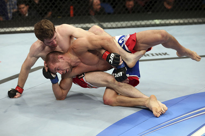 CALGARY, CANADA - JULY 21: (L-R) Mitch Clarke grapples Anton Kuivanen during their lightweight bout at UFC 149 inside the Scotiabank Saddledome on July 21, 2012 in Calgary, Alberta, Canada. (Photo by Nick Laham/Zuffa LLC/Zuffa LLC via Getty Images)