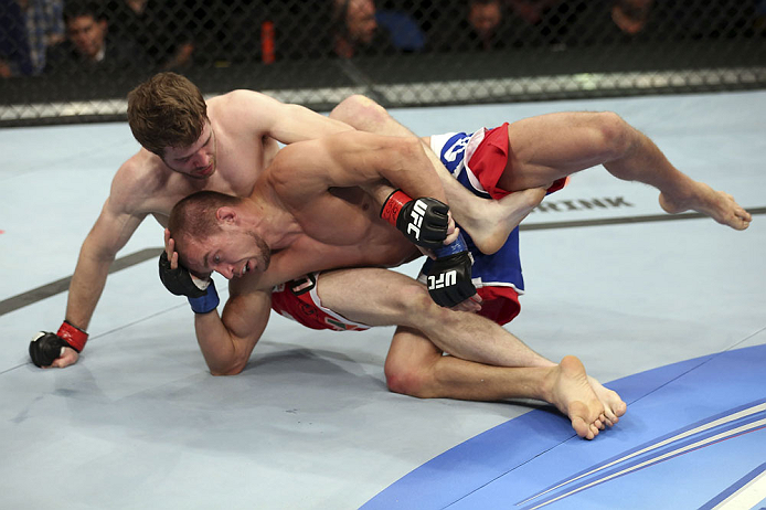 CALGARY, CANADA - JULY 21: (L-R) Mitch Clarke grapples Anton Kuivanen during their lightweight bout at UFC 149 inside the Scotiabank Saddledome on July 21, 2012 in Calgary, Alberta, Canada.  (Photo by Nick Laham/Zuffa LLC/Zuffa LLC via Getty Images)