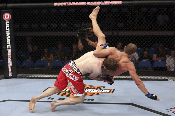 CALGARY, CANADA - JULY 21: (L-R) Mitch Clarke takes down Anton Kuivanen during their lightweight bout at UFC 149 inside the Scotiabank Saddledome on July 21, 2012 in Calgary, Alberta, Canada. (Photo by Nick Laham/Zuffa LLC/Zuffa LLC via Getty Images)