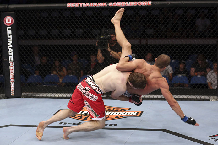 CALGARY, CANADA - JULY 21: (L-R) Mitch Clarke takes down Anton Kuivanen during their lightweight bout at UFC 149 inside the Scotiabank Saddledome on July 21, 2012 in Calgary, Alberta, Canada.  (Photo by Nick Laham/Zuffa LLC/Zuffa LLC via Getty Images)