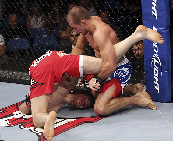 CALGARY, CANADA - JULY 21: (L-R) Mitch Clarke gets flipped by Anton Kuivanen during their lightweight bout at UFC 149 inside the Scotiabank Saddledome on July 21, 2012 in Calgary, Alberta, Canada. (Photo by Nick Laham/Zuffa LLC/Zuffa LLC via Getty Images