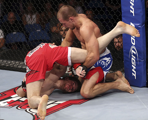 CALGARY, CANADA - JULY 21: (L-R) Mitch Clarke gets flipped by Anton Kuivanen during their lightweight bout at UFC 149 inside the Scotiabank Saddledome on July 21, 2012 in Calgary, Alberta, Canada.  (Photo by Nick Laham/Zuffa LLC/Zuffa LLC via Getty Images