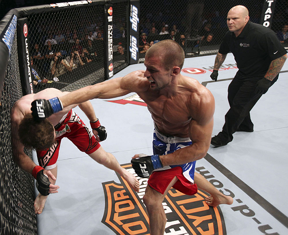 CALGARY, CANADA - JULY 21:  (R-L) Anton Kuivanen throws a punch at Mitch Clarke during their lightweight bout at UFC 149 inside the Scotiabank Saddledome on July 21, 2012 in Calgary, Alberta, Canada.  (Photo by Nick Laham/Zuffa LLC/Zuffa LLC via Getty Ima