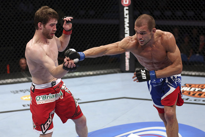 CALGARY, CANADA - JULY 21: (R-L) Anton Kuivanen throws a punch at Mitch Clarke during their lightweight bout at UFC 149 inside the Scotiabank Saddledome on July 21, 2012 in Calgary, Alberta, Canada. (Photo by Nick Laham/Zuffa LLC/Zuffa LLC via Getty Ima