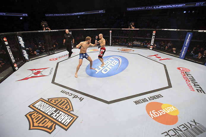 CALGARY, CANADA - JULY 21: (L-R) Bryan Caraway throws a punch at Mitch Gagnon during their bantamweight bout at UFC 149 inside the Scotiabank Saddledome on July 21, 2012 in Calgary, Alberta, Canada.  (Photo by Nick Laham/Zuffa LLC/Zuffa LLC via Getty Imag