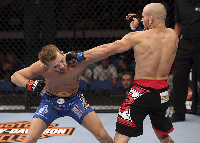 CALGARY, CANADA - JULY 21: (R-L) Mitch Gagnon lands a punch on Bryan Caraway during their bantamweight bout at UFC 149 inside the Scotiabank Saddledome on July 21, 2012 in Calgary, Alberta, Canada. (Photo by Nick Laham/Zuffa LLC/Zuffa LLC via Getty Imag