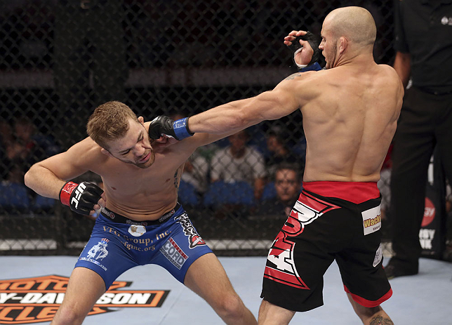 CALGARY, CANADA - JULY 21:  (R-L) Mitch Gagnon lands a punch on Bryan Caraway during their bantamweight bout at UFC 149 inside the Scotiabank Saddledome on July 21, 2012 in Calgary, Alberta, Canada.  (Photo by Nick Laham/Zuffa LLC/Zuffa LLC via Getty Imag